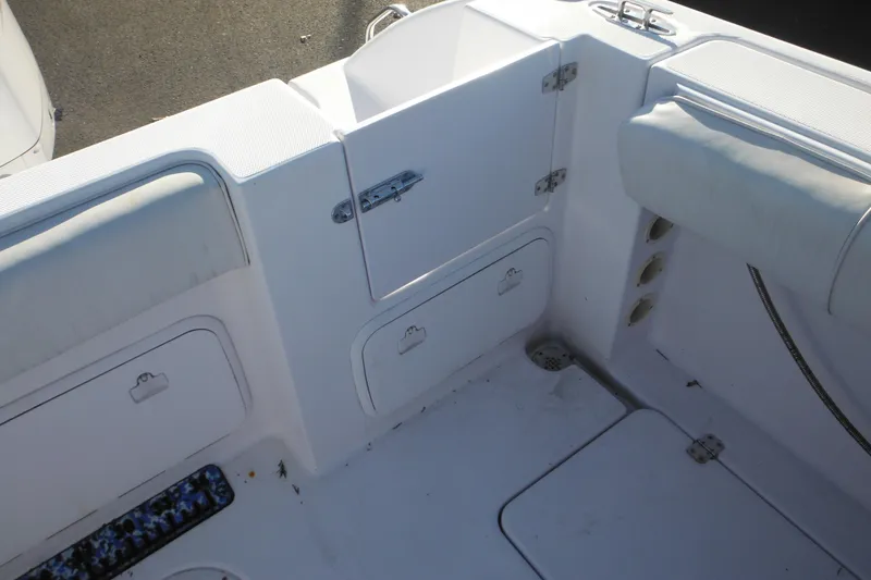 Slide: The Image of 2000 Pro-Line 23 Walkaround boat interior with storage compartments and seating. - 26