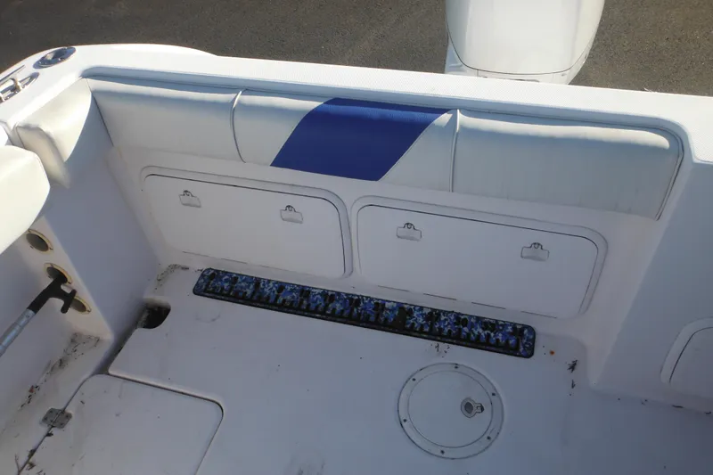 Slide: The Image of 2000 Pro-Line 23 Walkaround boat interior with storage compartments and seating. - 27