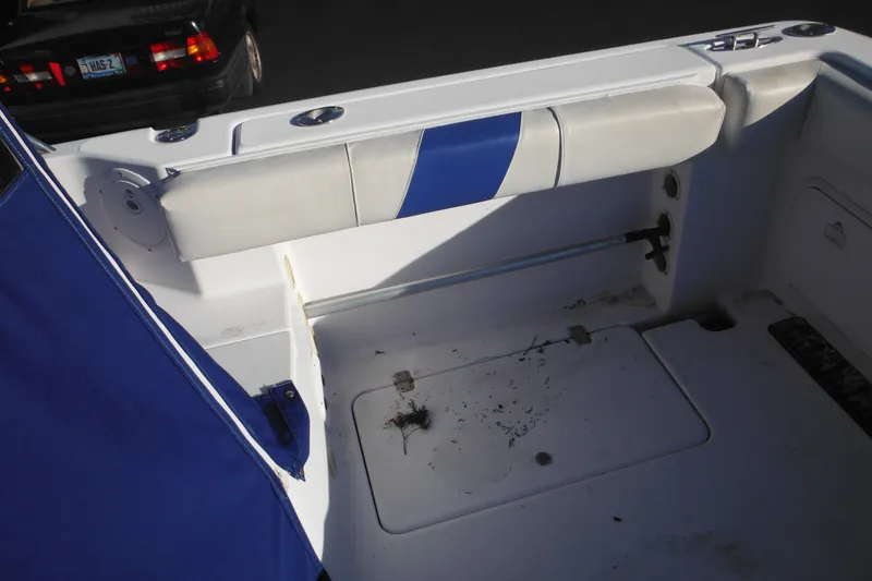 Slide: The Image of 2000 Pro-Line 23 Walkaround boat interior with blue and white seating. - 28