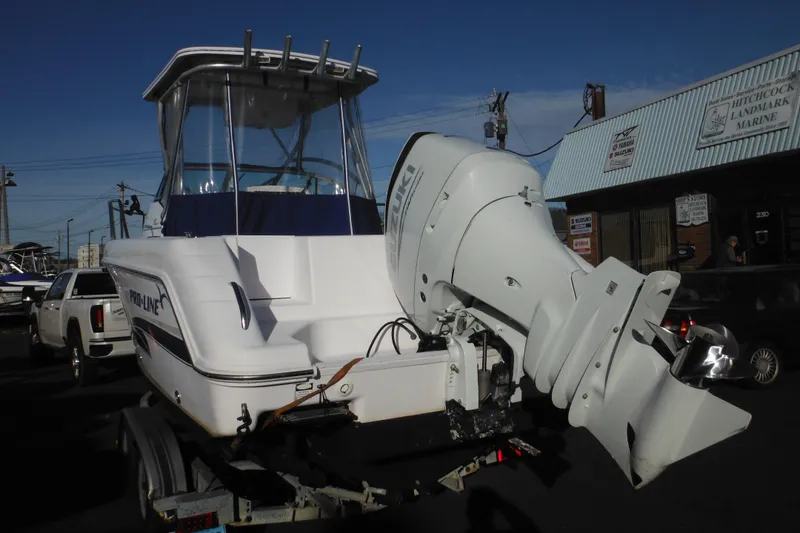 Slide: The Image of 2000 Pro-Line 23 Walkaround boat with outboard motor on trailer. - 3