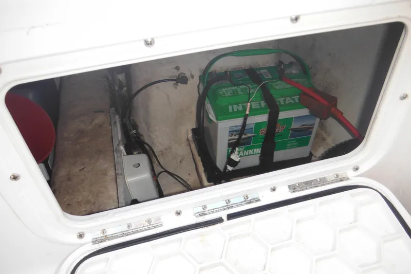 Slide: The Image of Battery compartment of a 2000 Pro-Line 23 Walkaround boat, featuring an Interstate marine battery. - 32