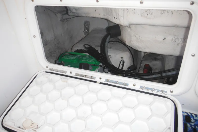 Slide: The Image of Battery compartment of a 2000 Pro-Line 23 Walkaround boat, showing wiring and connections. - 34