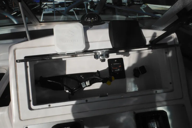 Slide: The Image of 2000 Pro-Line 23 Walkaround boat dashboard with compass and controls. - 37