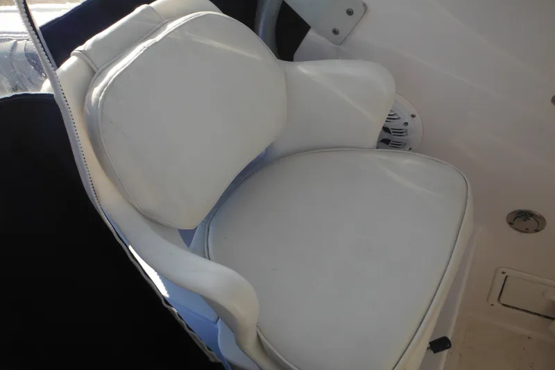 Slide: The Image of White cushioned seat on 2000 Pro-Line 23 Walkaround boat interior. - 38