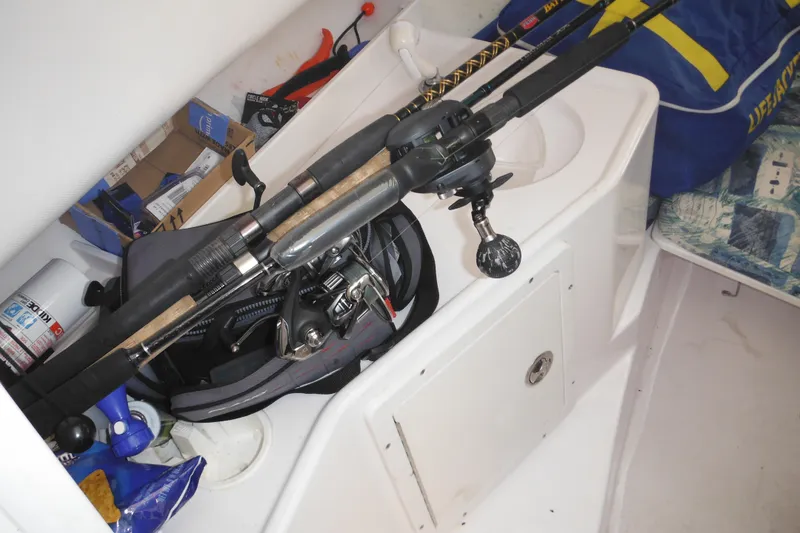 Slide: The Image of Interior of 2000 Pro-Line 23 Walkaround with fishing gear and supplies. - 43