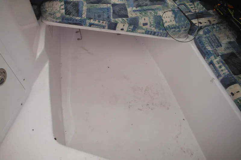 Slide: The Image of Interior view of a 2000 Pro-Line 23 Walkaround boat with patterned seating. - 44