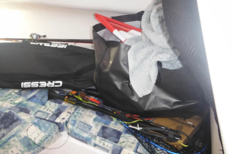 Slide: The Image of Interior of 2000 Pro-Line 23 Walkaround with fishing gear and equipment storage. - 45