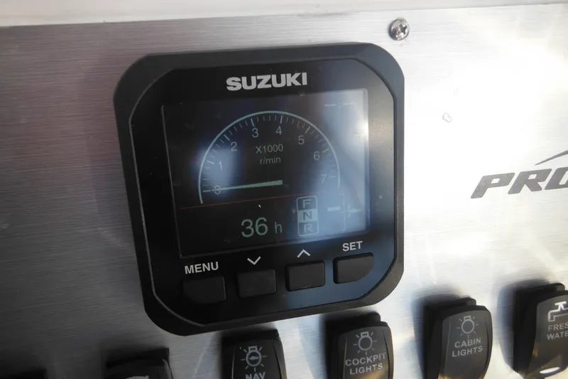 Slide: The Image of Suzuki gauge on 2000 Pro-Line 23 Walkaround boat dashboard, showing 36 hours. - 47