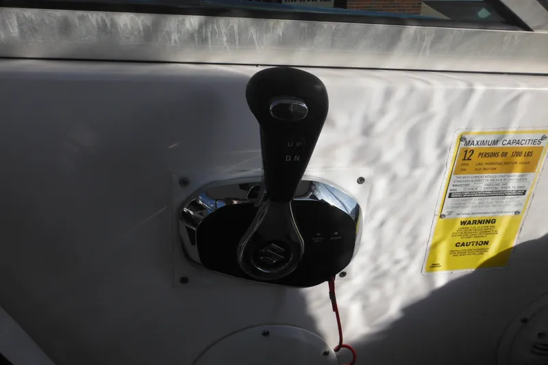 Slide: The Image of Throttle control on a 2000 Pro-Line 23 Walkaround boat, with capacity warning label. - 49