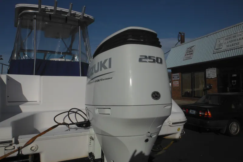 Slide: The Image of 2000 Pro-Line 23 Walkaround boat with Suzuki 250 outboard motor at a marine shop. - 7