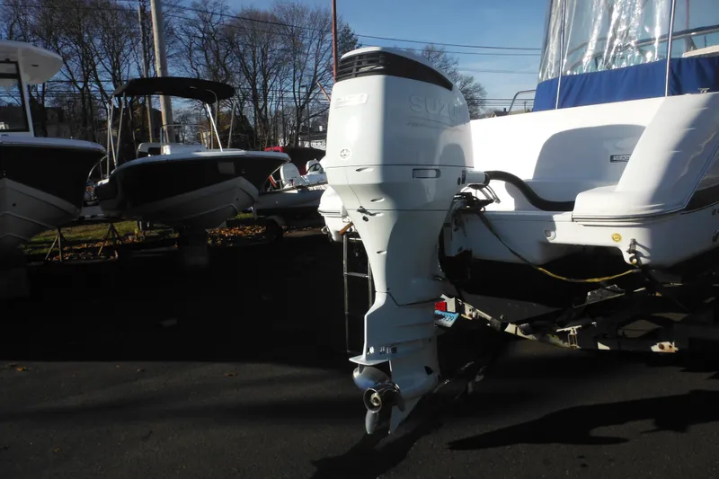 Slide: The Image of 2000 Pro-Line 23 Walkaround boat with Suzuki outboard motor in a marina setting. - 9