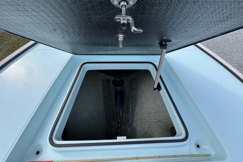 Slide: The Image of Open storage compartment of 2024 East Cape EVO 18 boat, showcasing interior details. - 17