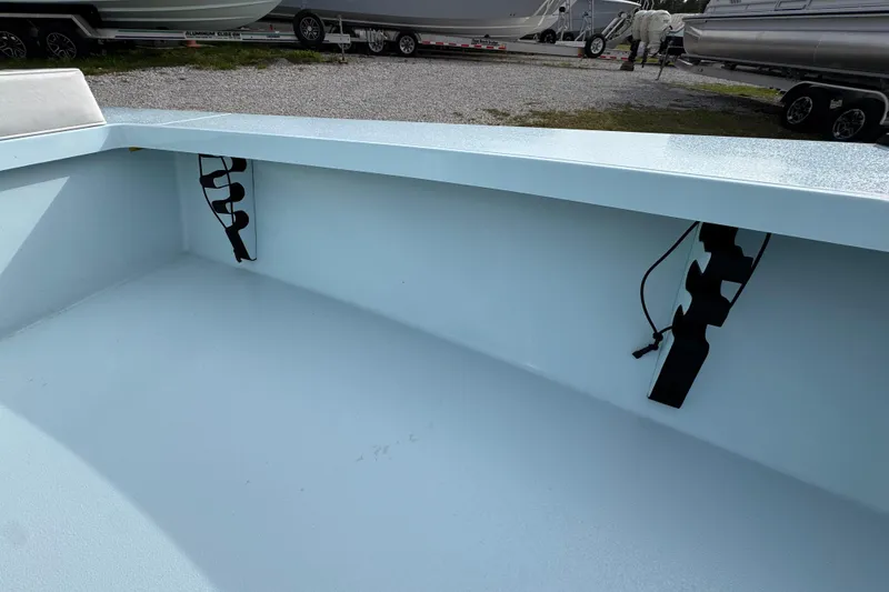 Slide: The Image of 2024 East Cape EVO 18 boat interior with rod holders and clean deck design. - 21