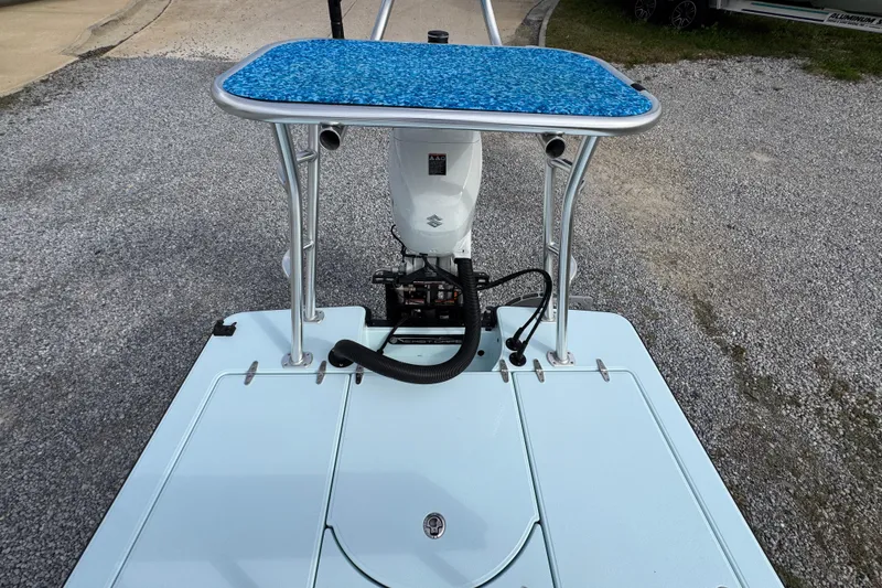 Slide: The Image of 2024 East Cape EVO 18 boat with blue poling platform and outboard motor. - 27