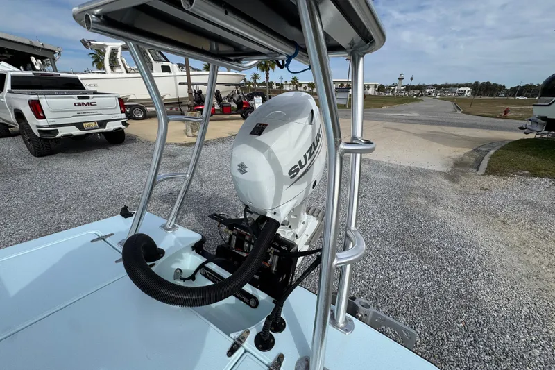 Slide: The Image of 2024 East Cape EVO 18 boat with Suzuki outboard motor in a marina setting. - 29