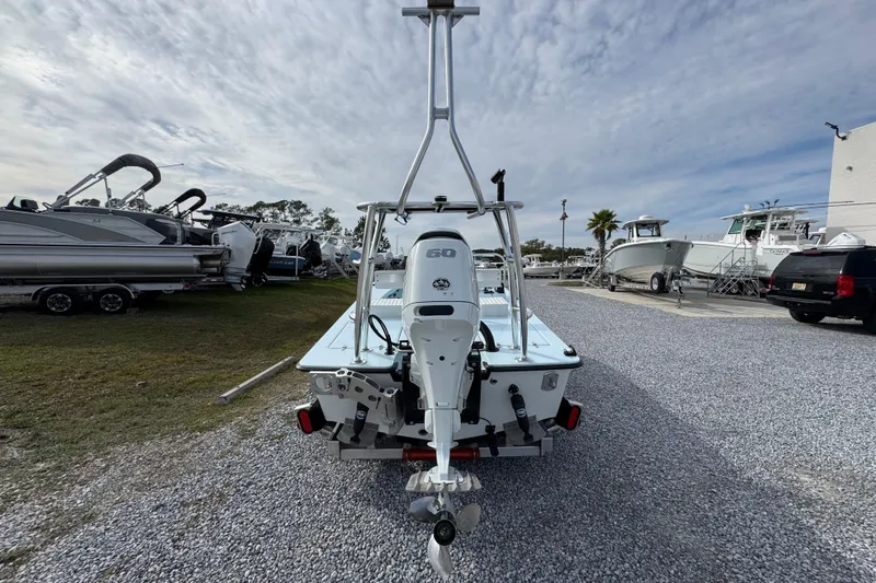 Slide: The Image of 2024 East Cape EVO 18 boat with outboard motor in a marina setting. - 6