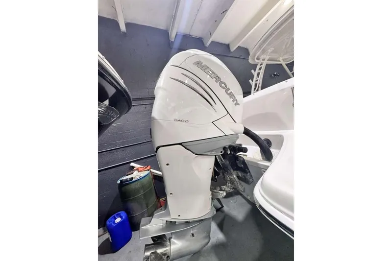 Slide: The Image of 2018 Boston Whaler 230 Vantage with Mercury outboard engine in a garage setting. - 14