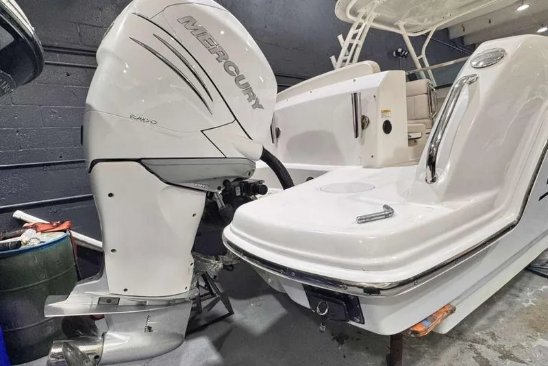 Slide: The Image of 2018 Boston Whaler 230 Vantage with Mercury outboard engine in a showroom. - 15