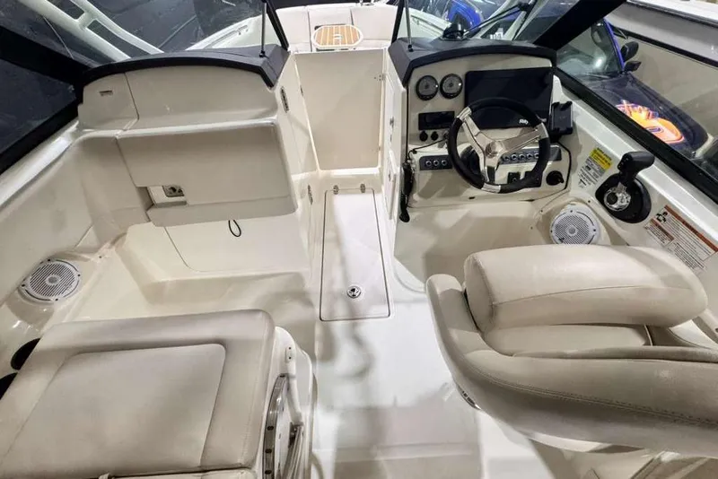 Slide: The Image of 2018 Boston Whaler 230 Vantage boat interior with steering wheel and seating. - 2