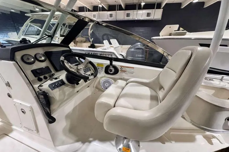 Slide: The Image of 2018 Boston Whaler 230 Vantage boat interior with steering wheel and captain's seat. - 7