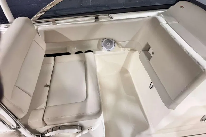 Slide: The Image of 2018 Boston Whaler 230 Vantage interior seating with white upholstery and speaker. - 9
