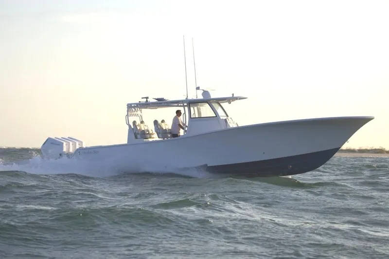 The Image of 2027 Onslow Bay 41 Tournament Edition boat cruising on open water at sunset. - 0