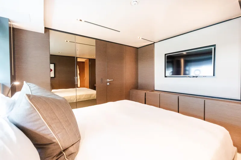 Slide: The Image of Luxurious bedroom interior on 2018 Custom Line Navetta 33 yacht, featuring modern decor and TV. - 35