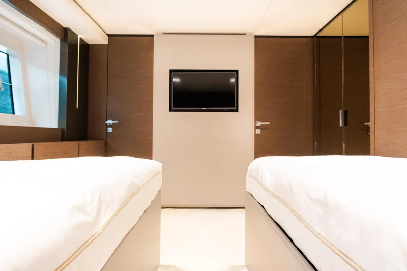 Slide: The Image of Luxurious cabin interior of 2018 Custom Line Navetta 33 yacht with twin beds and TV. - 41