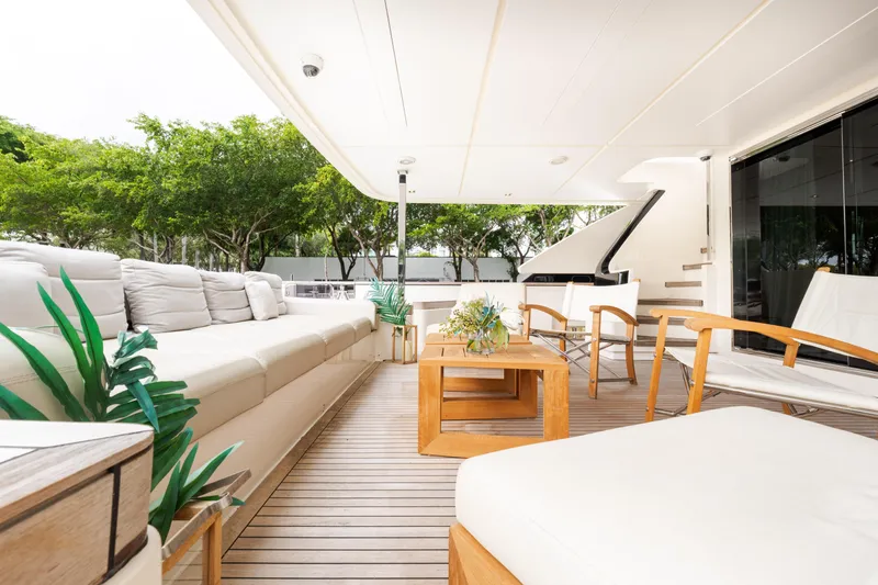 Slide: The Image of Luxurious 2018 Custom Line Navetta 33 yacht deck with elegant seating and wooden accents. - 5