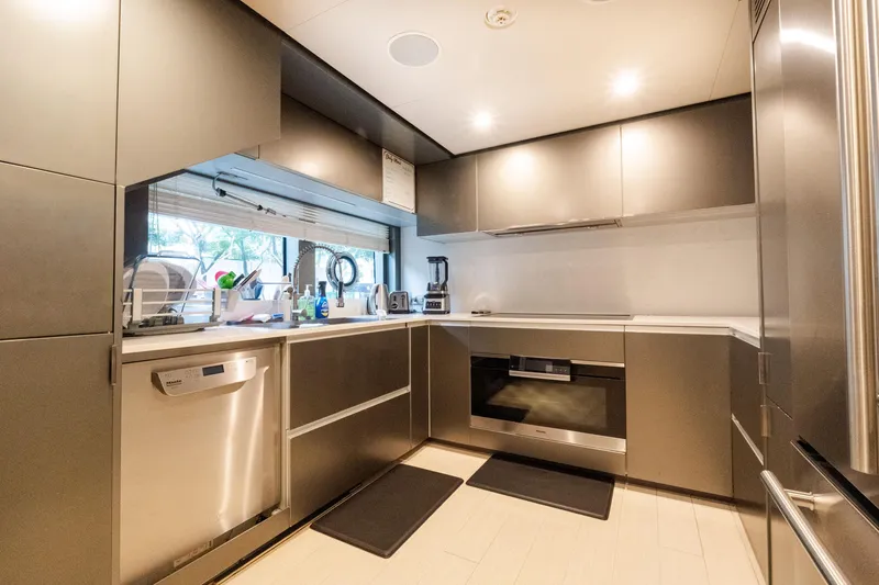 Slide: The Image of Modern kitchen interior on 2018 Custom Line Navetta 33 yacht, featuring sleek cabinetry and appliances. - 52