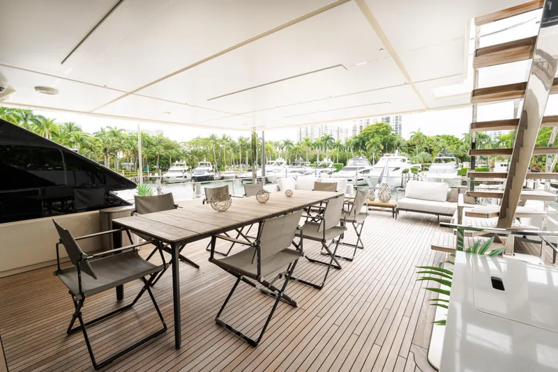 Slide: The Image of Luxurious 2018 Custom Line Navetta 33 yacht deck with elegant seating and marina view. - 60