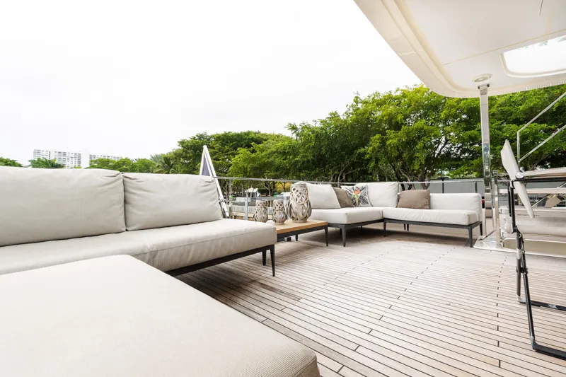 Slide: The Image of Luxurious outdoor seating on 2018 Custom Line Navetta 33 yacht deck, surrounded by greenery. - 61