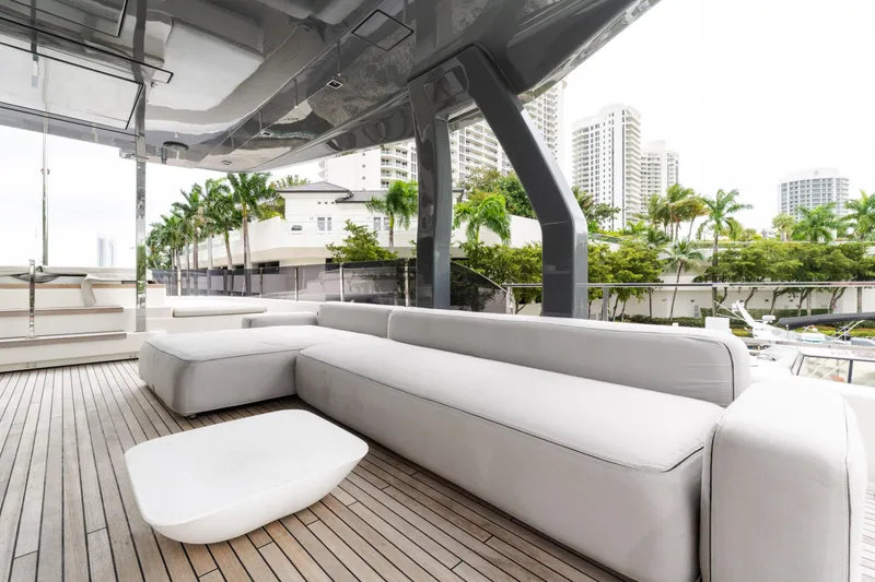 Slide: The Image of Luxurious 2018 Custom Line Navetta 33 yacht deck with modern seating and cityscape view. - 65