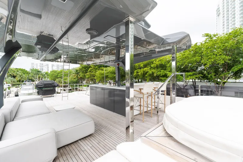 Slide: The Image of Luxurious 2018 Custom Line Navetta 33 yacht deck with modern seating and bar area. - 68