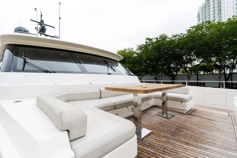 Slide: The Image of Luxurious 2018 Custom Line Navetta 33 yacht with elegant outdoor seating and wooden deck. - 9
