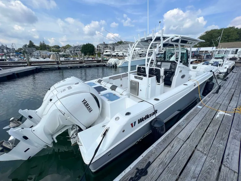 Slide: The Image of 2024 Wellcraft 302 Fisherman boat docked with Yamaha engines. - 10