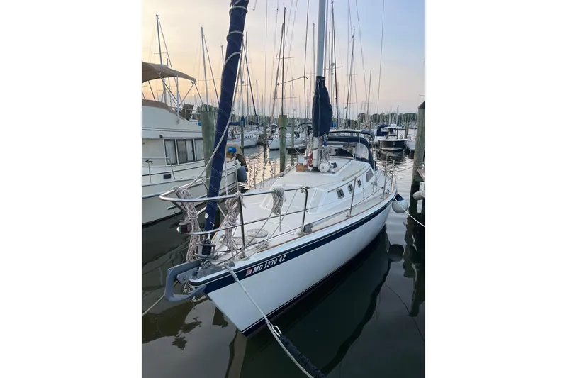 Slide: The Image of 1982 O'Day 34 sailboat docked at marina during sunset. - 13