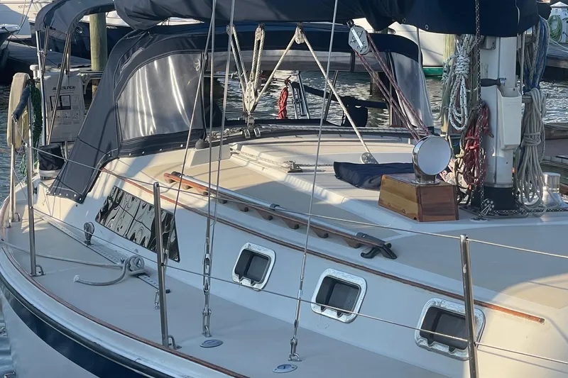 Slide: The Image of 1982 O'Day 34 sailboat docked, featuring a spacious deck and rigging details. - 14