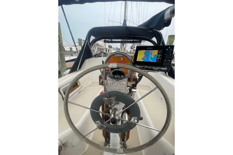 Slide: The Image of 1982 O'Day 34 sailboat cockpit with steering wheel and navigation system. - 17