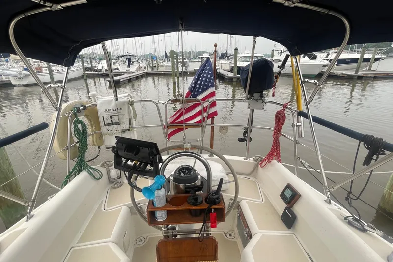 Slide: The Image of Cockpit of 1982 O'Day 34 sailboat with American flag at marina. - 19