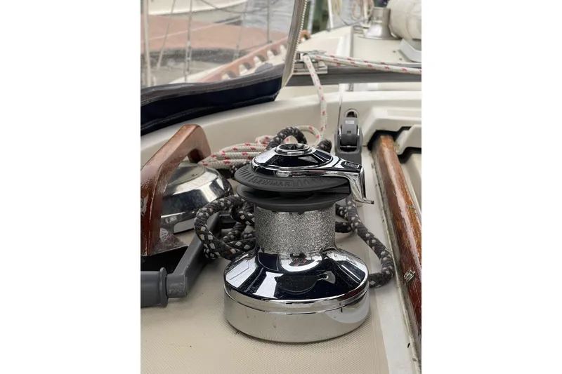 Slide: The Image of Winch on 1982 O'Day 34 sailboat deck with ropes and wooden accents. - 21