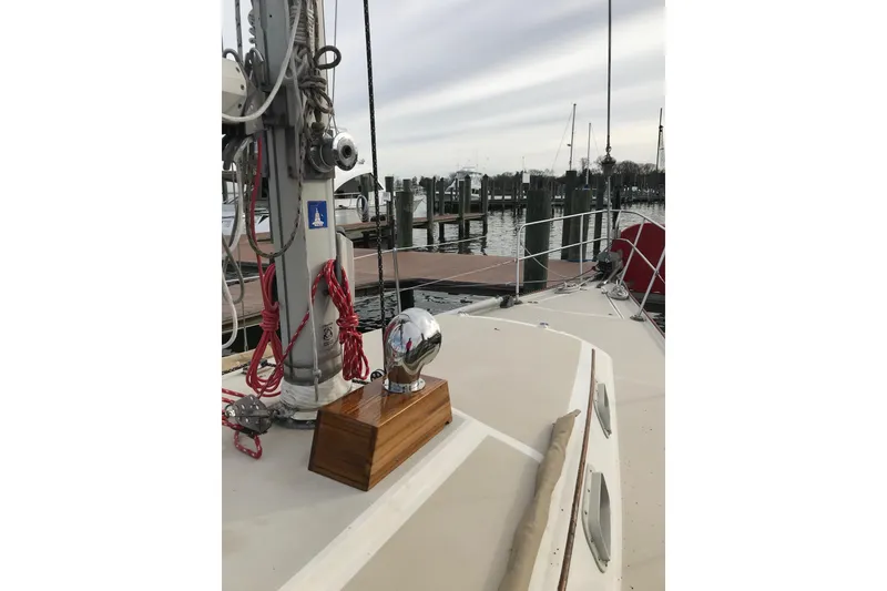 Slide: The Image of 1982 O'Day 34 sailboat deck with a wooden trophy, docked at a marina. - 22