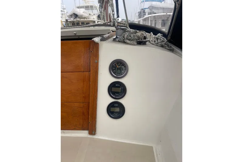 Slide: The Image of 1982 O'Day 34 sailboat cockpit with gauges and wooden panel. - 26