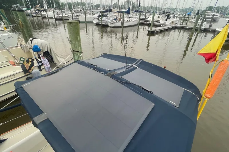 Slide: The Image of 1982 O'Day 34 sailboat with solar panels docked at a marina. - 27