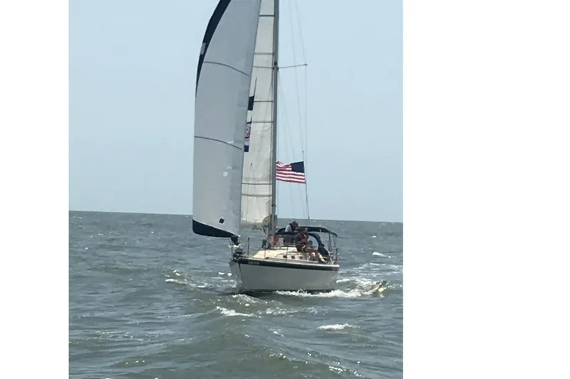 Slide: The Image of 1982 O'Day 34 sailboat on the sea with US flag. - 3