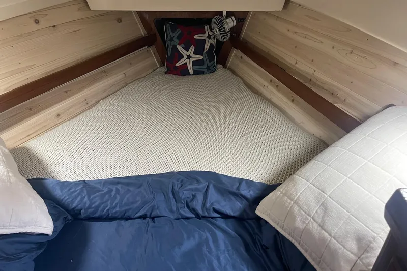 Slide: The Image of Cozy cabin interior of 1982 O'Day 34 sailboat with nautical-themed bedding. - 32