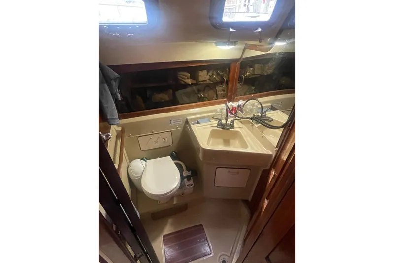 Slide: The Image of 1982 O'Day 34 yacht bathroom with sink, toilet, and mirror. - 34