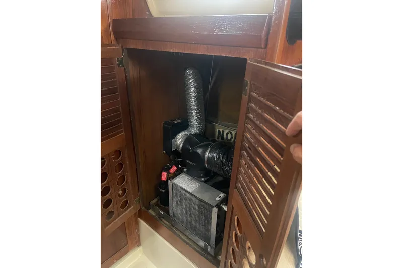 Slide: The Image of 1982 O'Day 34 sailboat engine compartment with wooden louvered door open. - 36