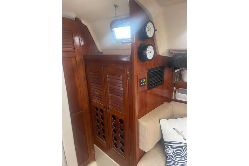 Slide: The Image of Interior of 1982 O'Day 34 sailboat with wooden cabinetry and nautical instruments. - 37