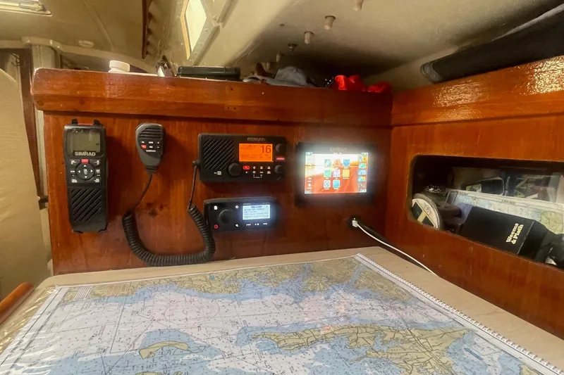 Slide: The Image of Navigation station on 1982 O'Day 34 sailboat with radio equipment and nautical chart. - 38